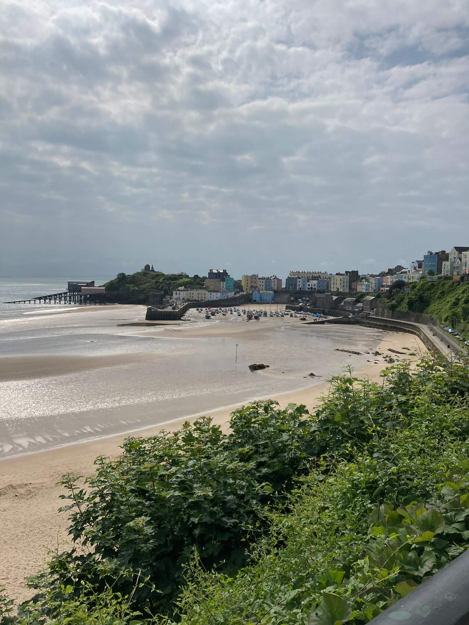 Painted houses on cliffs overlooking white sandy beach